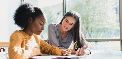 Counselor helping a student at a table